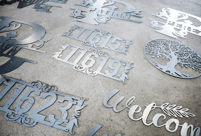 Metal decorative signs with numbers and text on a concrete surface